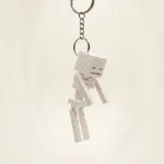 جاکلیدی اسکلت ماینکرفت با طراحی الهام گرفته از Skeleton محبوب بازی Minecraft. ساخته شده با پرینت سه‌بعدی باکیفیت، مناسب کلید، کیف، کوله‌پشتی و کلکسیون گیمرها.